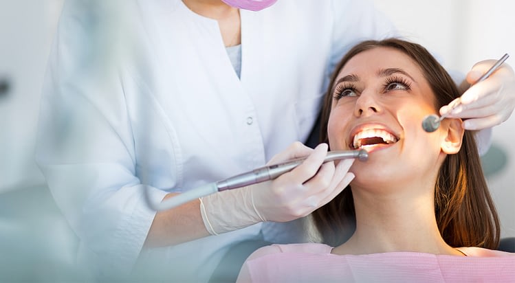 Smiles By Bis image showing a woman receiving dental treatment